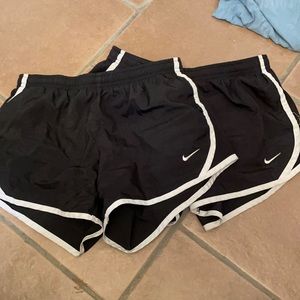two black and white nike shorts